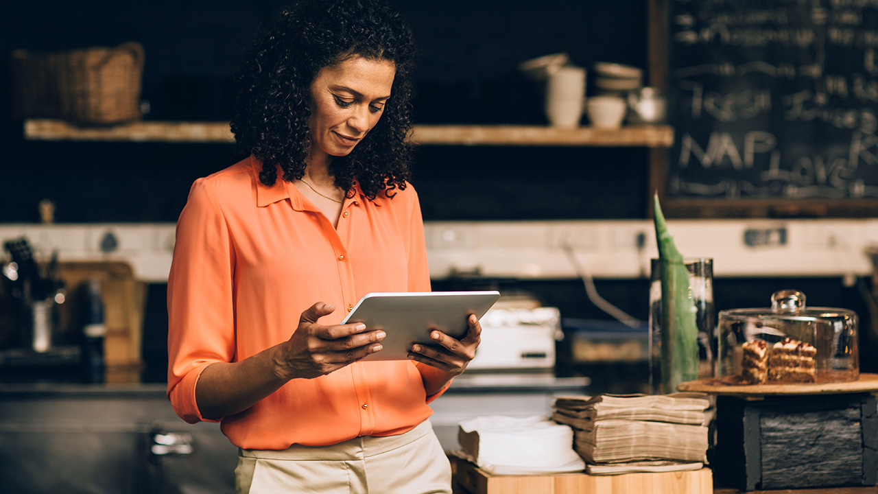 Cafe owner looking at her ipad